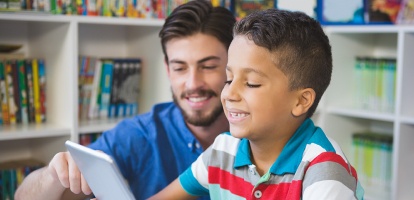 elementary aged student working on a laptop