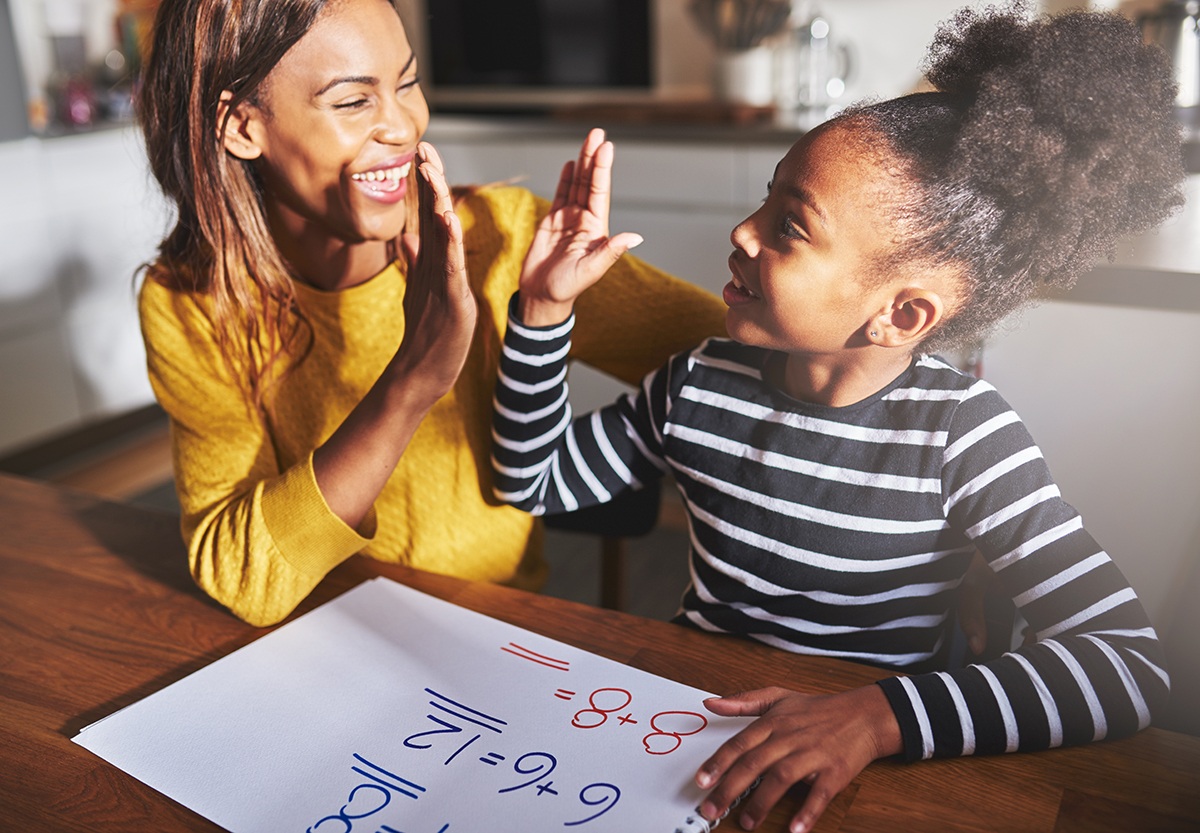 parent congratulates child with a high-five