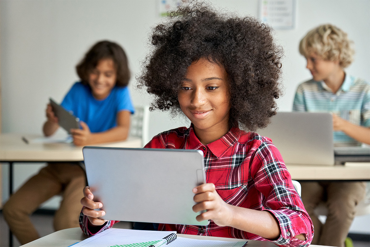 student in a classroom on a tablet