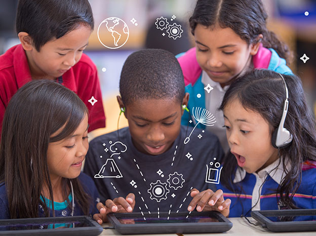 Elementary students wearing headphones and working on tablets