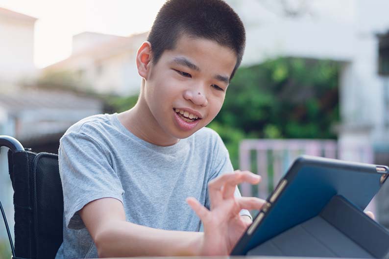 Student in a wheelchair on a tablet