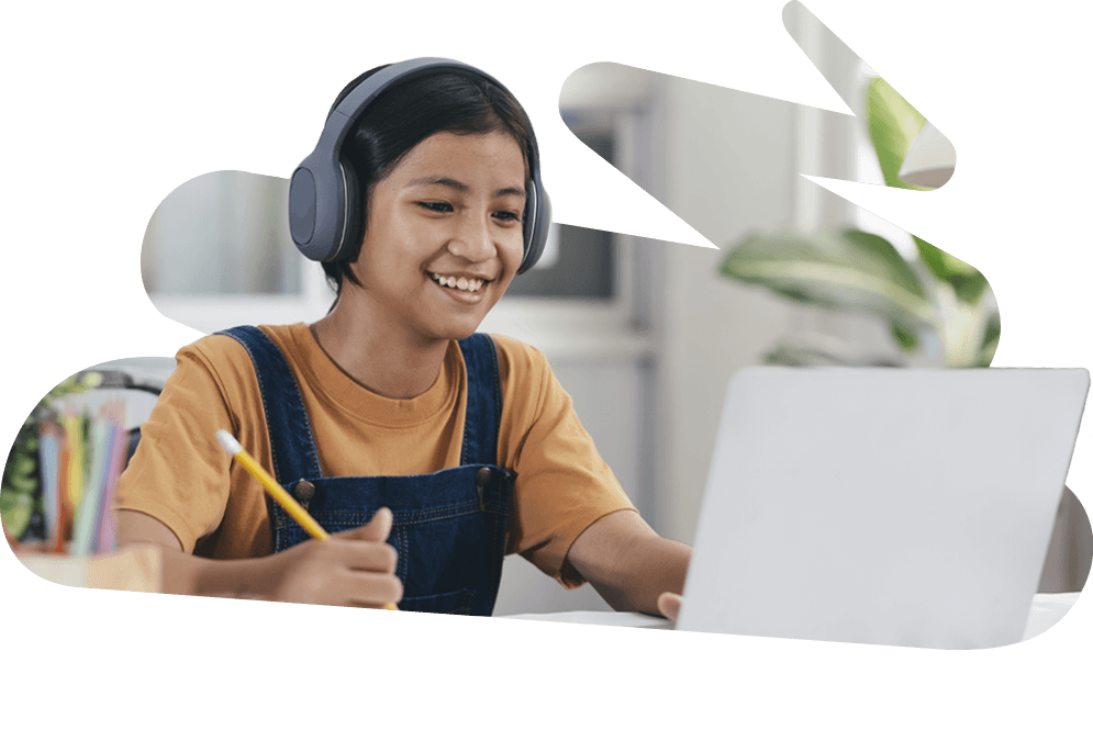 Elementary school student smiling and working on laptop