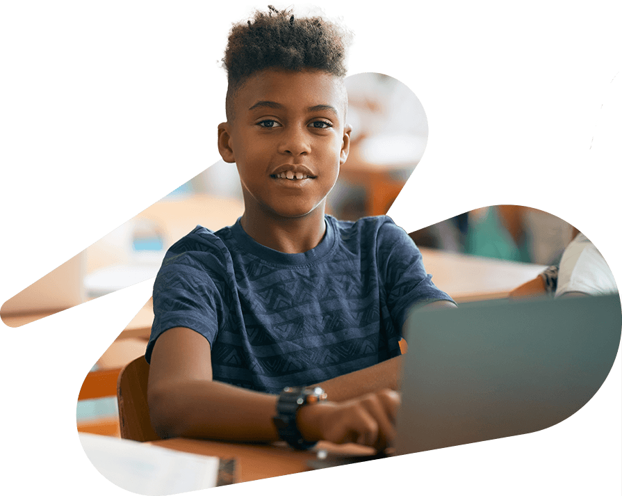 Elementary school student working on laptop in a classroom