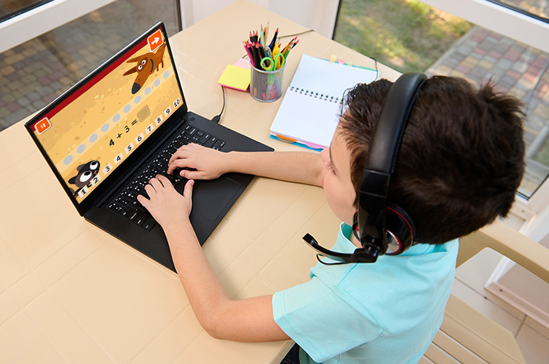 Elementary student engaging in an interactive lesson on a laptop