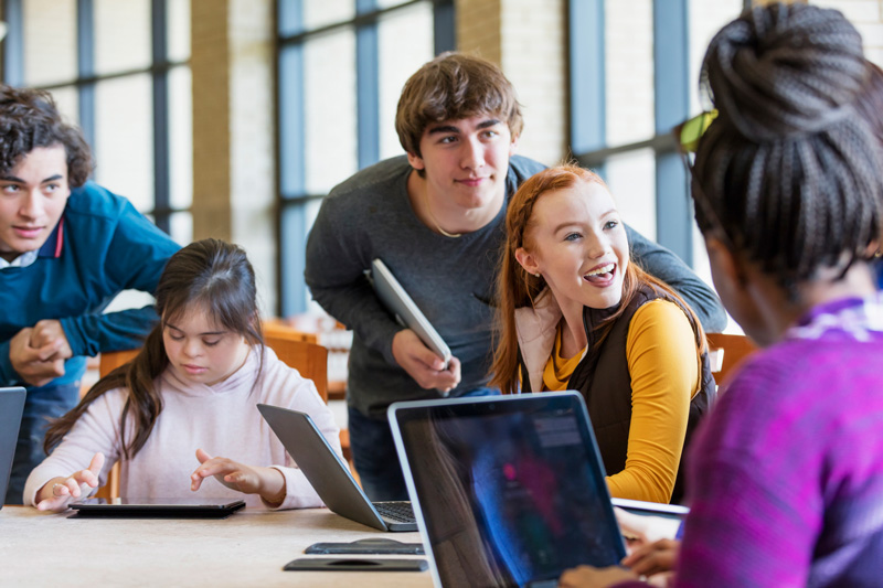 A group of high school students collaborating in a library.