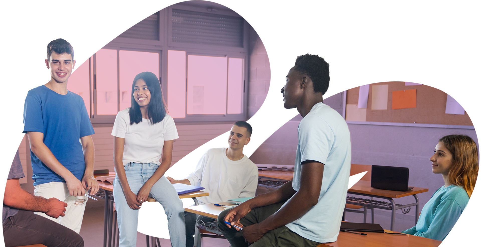Five high school students gathered in front of their instructor at desks. One student is standing, while the others are more casually seated.