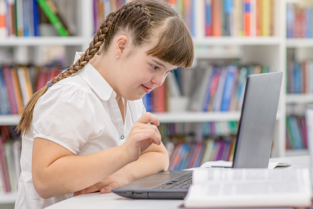 An educator teaching an online class, with a whiteboard and camera