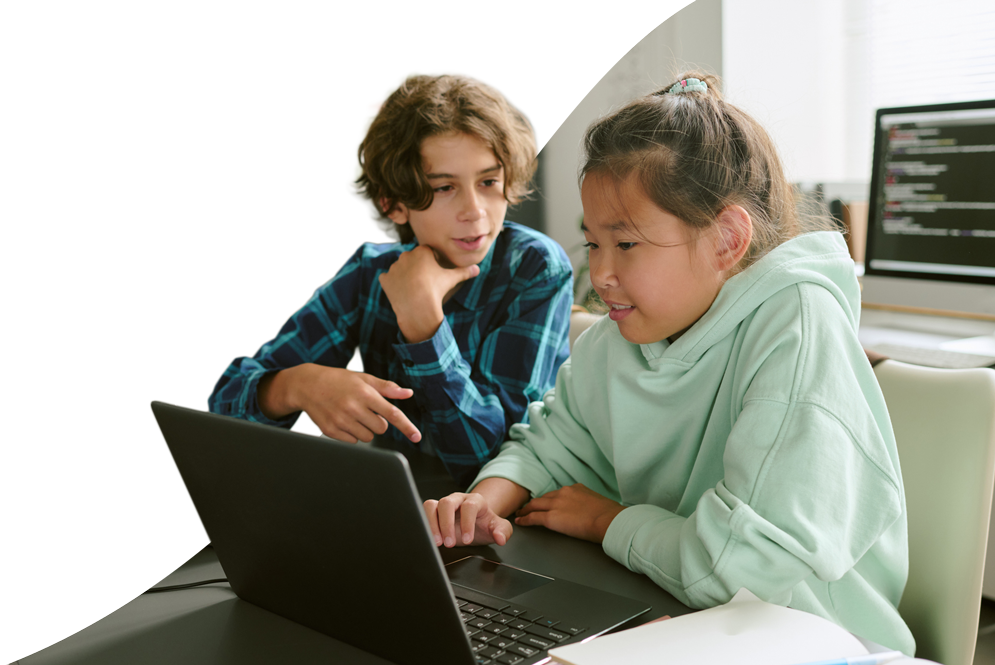 High school student typing on a computer keyboard.
