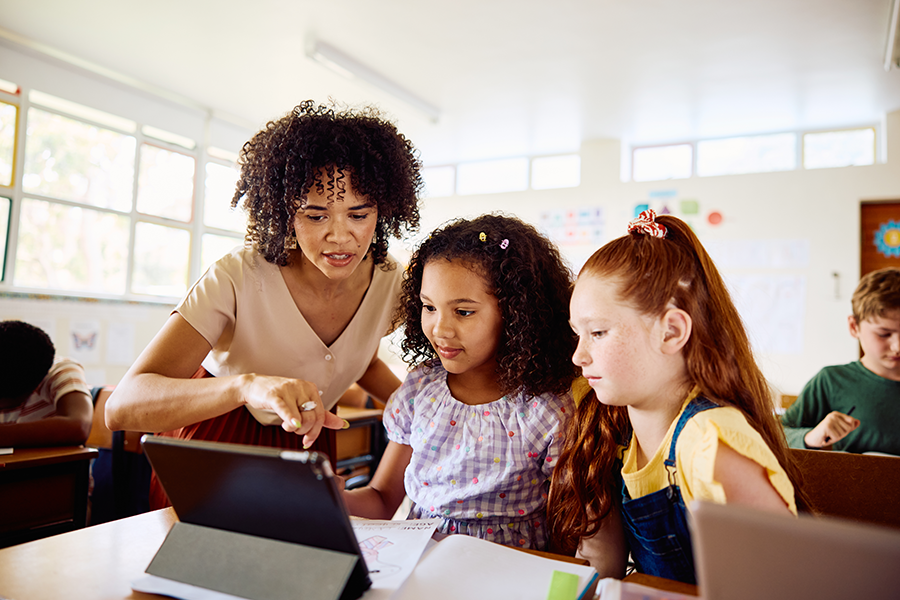 Teacher in classroom helping students