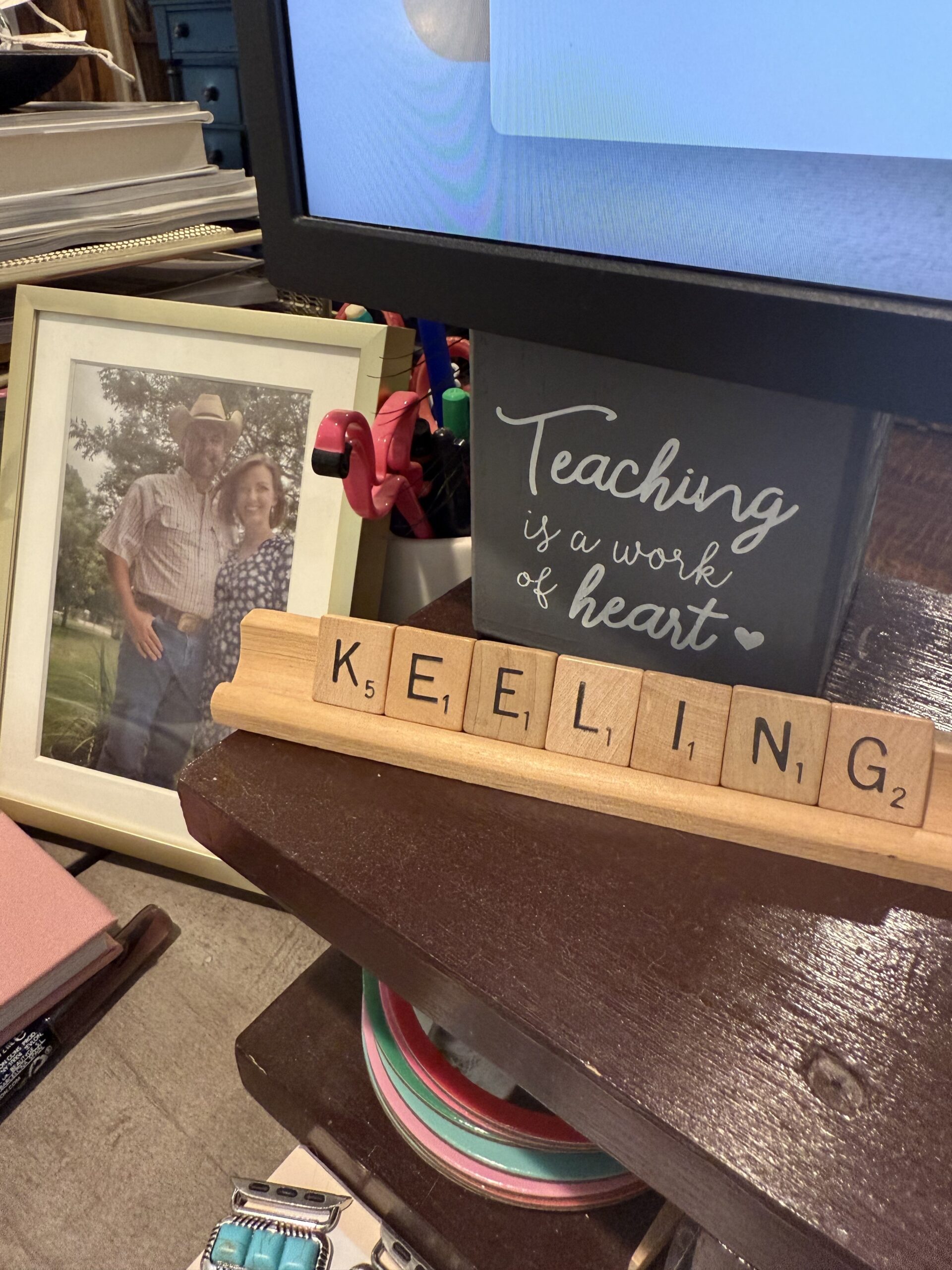 An image of a photo frame, a sign that says 'Teaching is a work of Heart' and some wooden letters that spell out 'Keeling'
