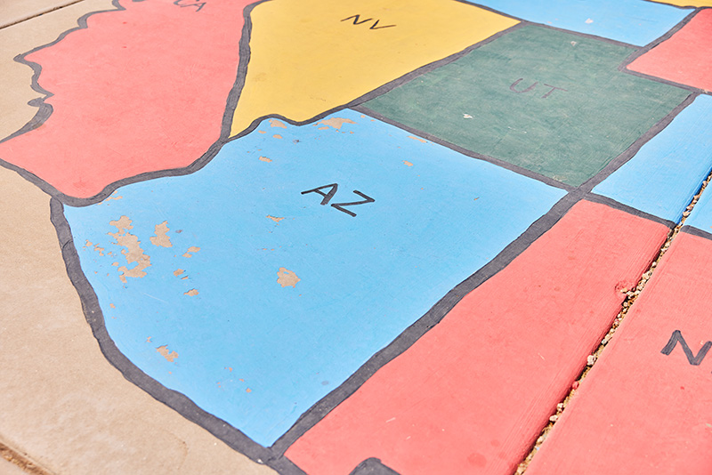 A group of educators pose for a photo in front of a backdrop.