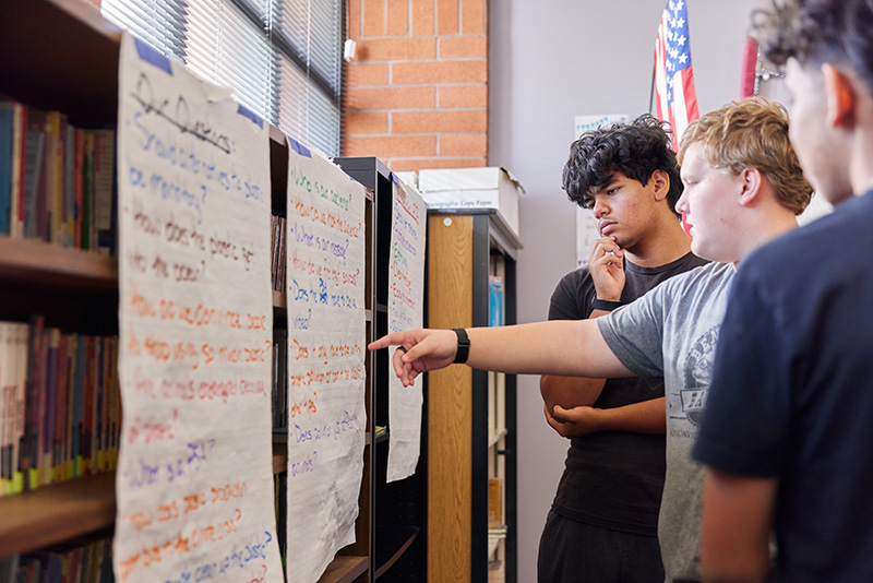 A group of educators pose for a photo in front of a backdrop.