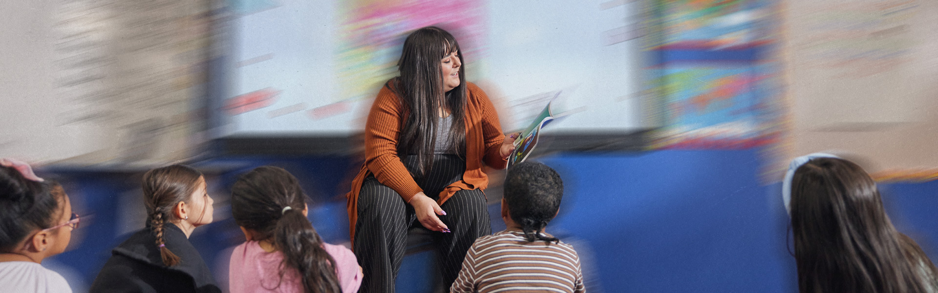 Teacher reading to kids in a classroom