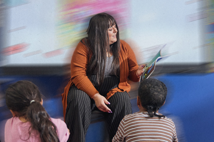 A student engages in a lesson activity, holding up his drawing.