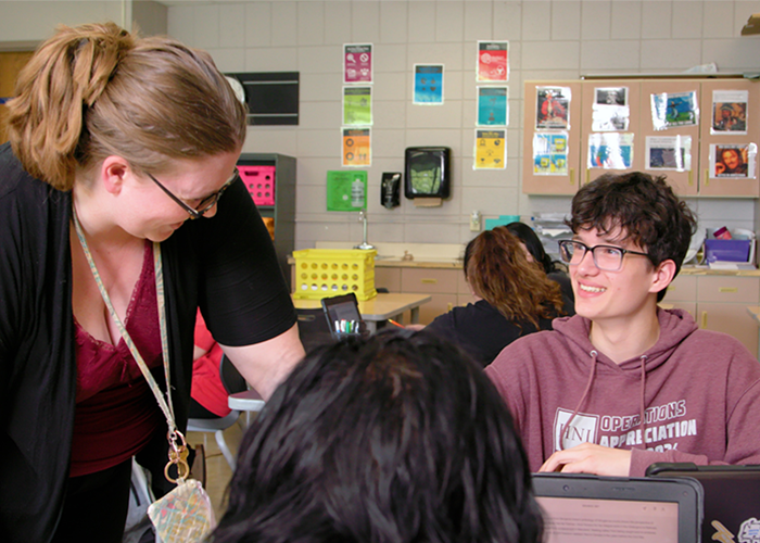 Teacher having a discussion with students.