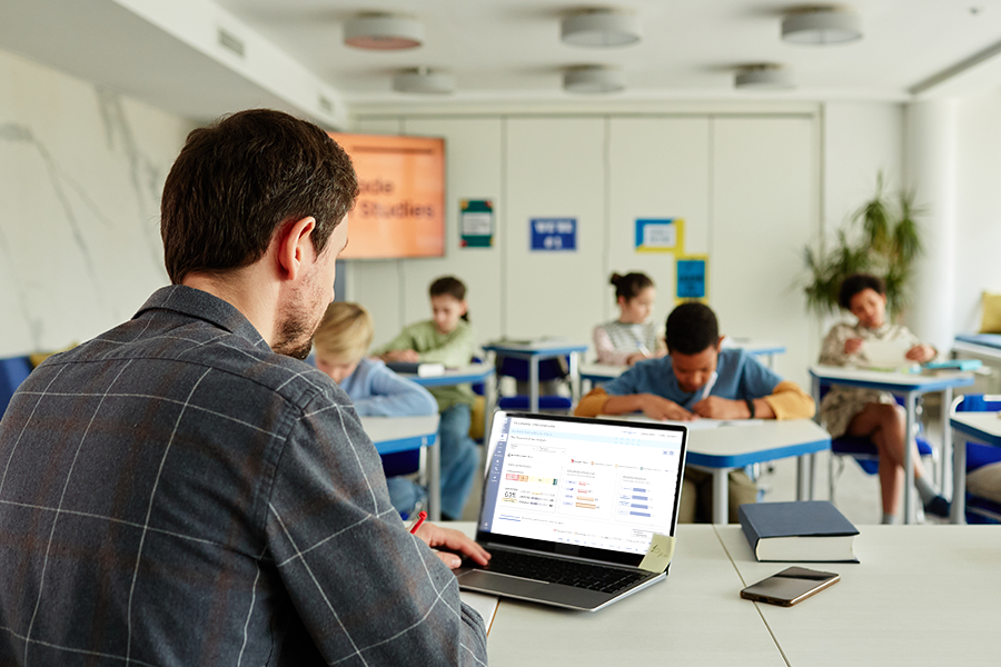 teacher at the front of class reviewing assessments