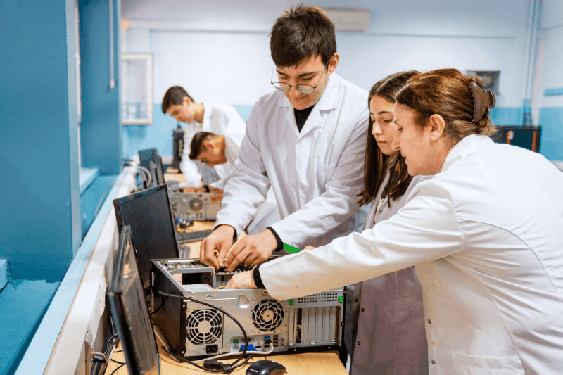 a group of people fixing an open computer