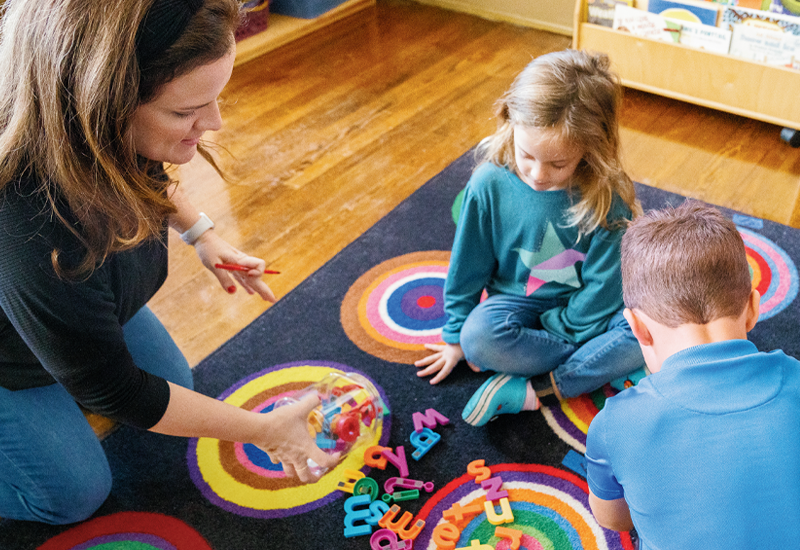 Teacher playing a flash card literacy game with students