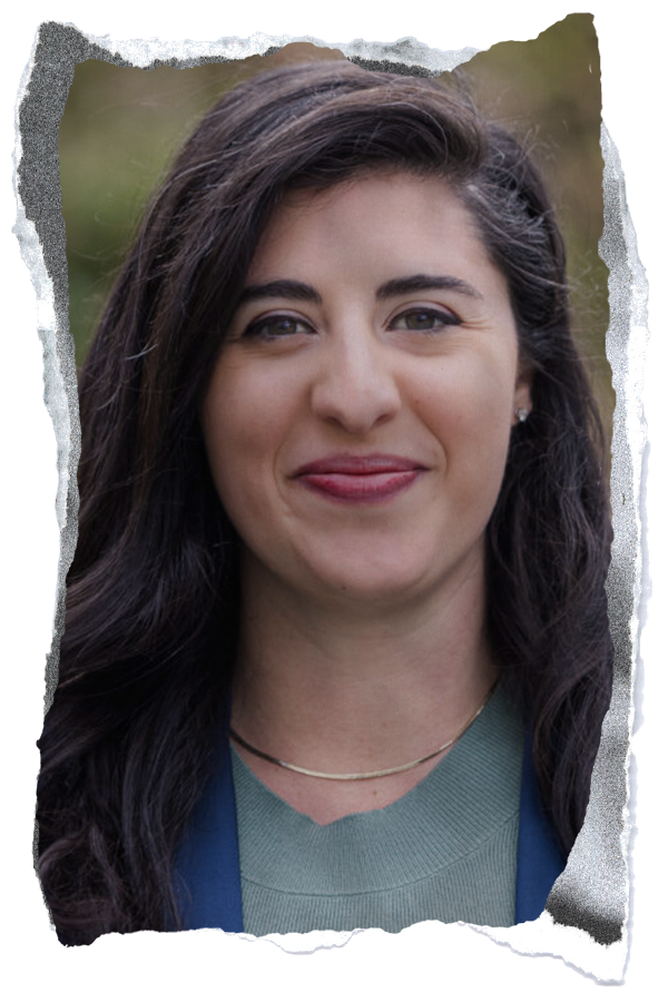 A brunette woman in teal gray blouse