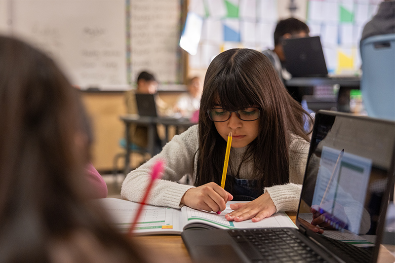 students writing in workbooks