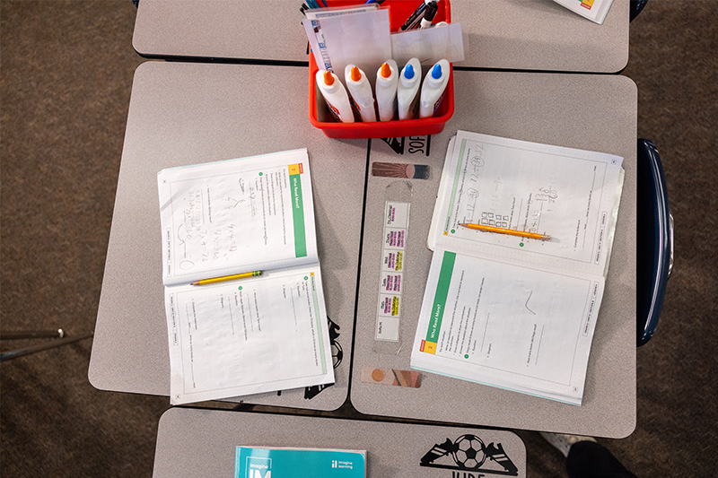 desks with workbooks and other school supplies