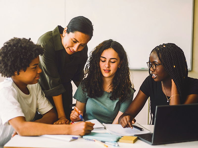 teacher with a small group of students working together
