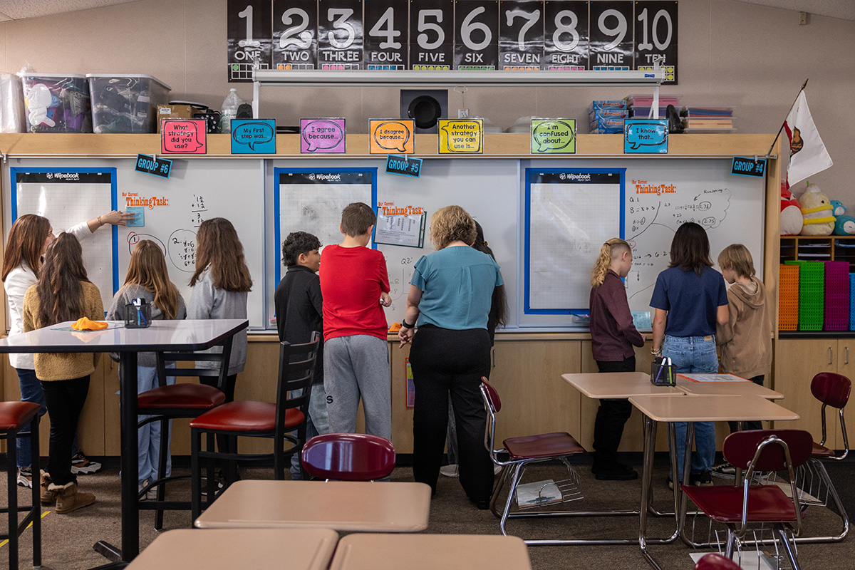 Image of student using manipulatives to solve a math puzzle.
